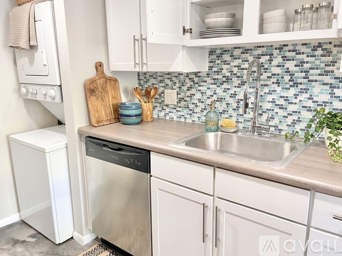A kitchen with a stove, oven, microwave, and refrigerator.