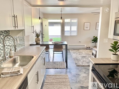 A kitchen with a marble floor and a central island.