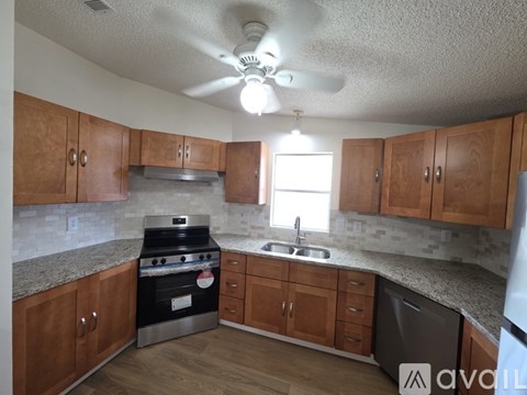 A kitchen with wooden cabinets and a black stove top oven.