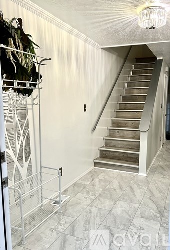 A staircase with a metal railing and wooden steps.