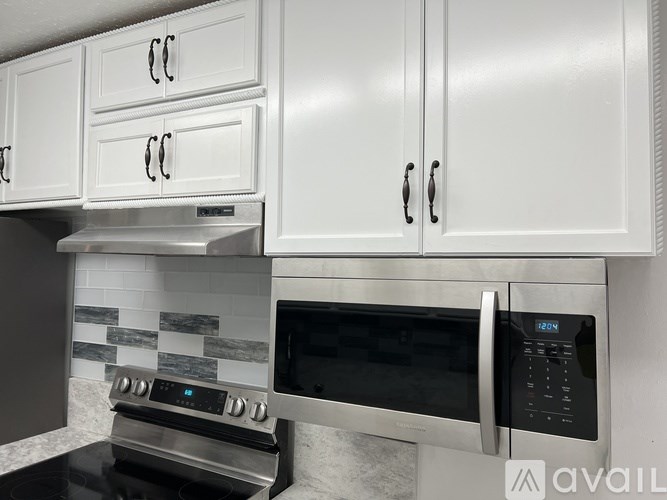 A modern kitchen with a stove, oven, and microwave.