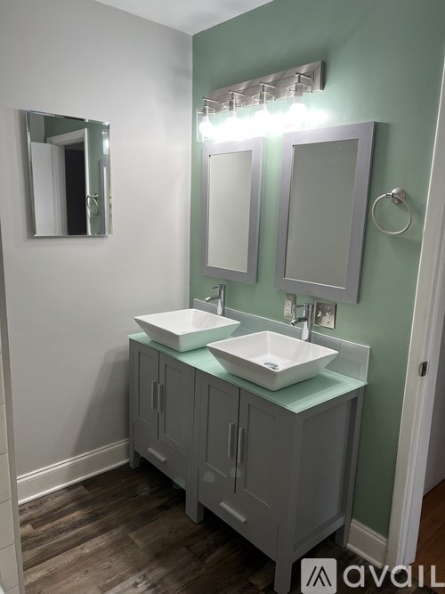 A bathroom with two sinks and a mirror.