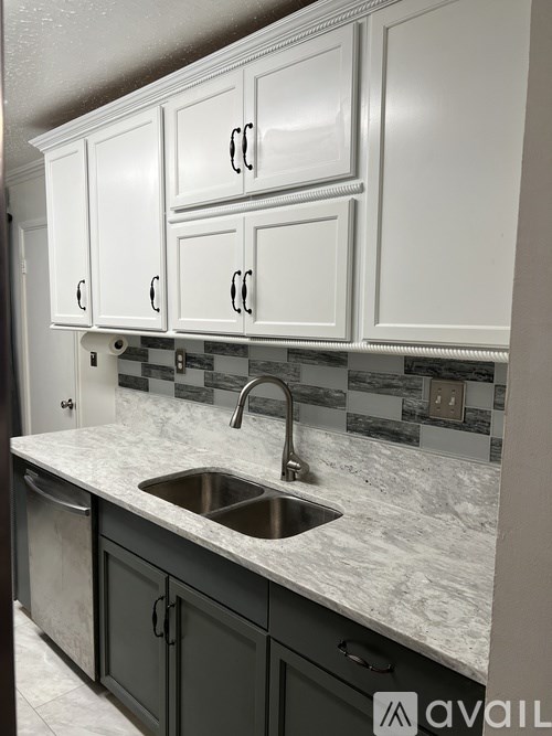 A kitchen with a sink and cabinets.