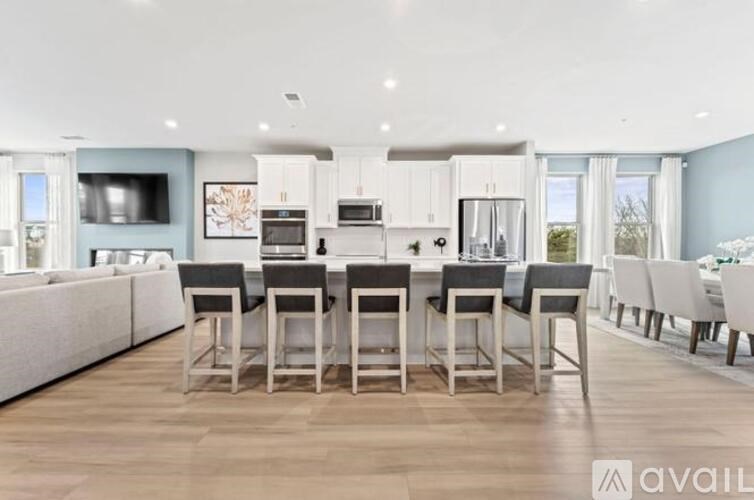 A modern kitchen with a dining table set up.