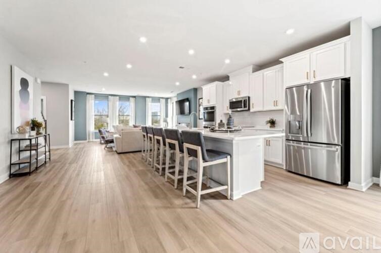 A modern kitchen with a bar area and a dining table.