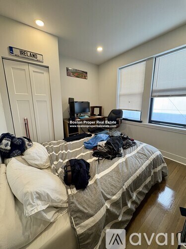 A bedroom with a bed, a window, and a sign that says "IRELAND".