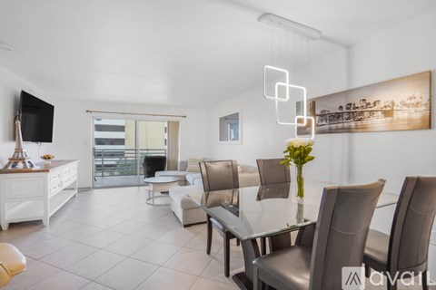 A modern living room with a glass table and chairs.