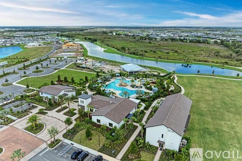 A bird's eye view of a resort with a swimming pool and a river.