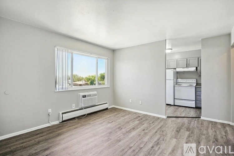 A room with a window and a washing machine.