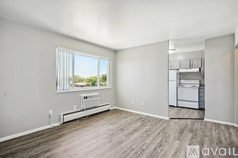 A room with a window and a washing machine.