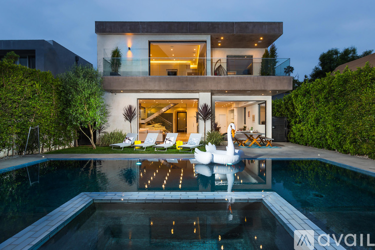 A modern house with a pool in the backyard.