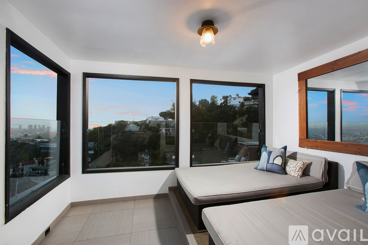 A bedroom with a large bed and a view of the city.