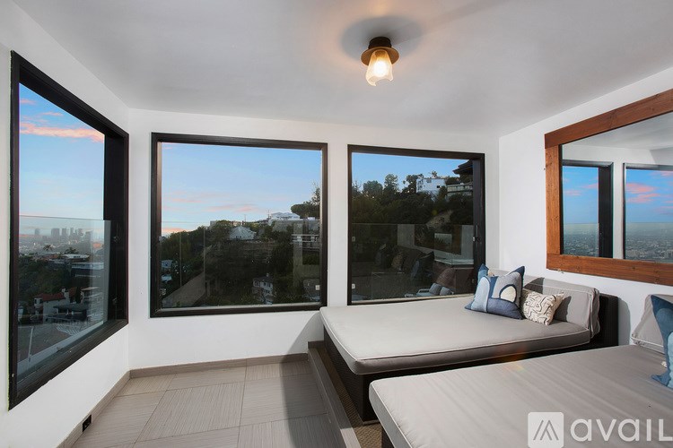 A bedroom with a large bed and a view of the city.