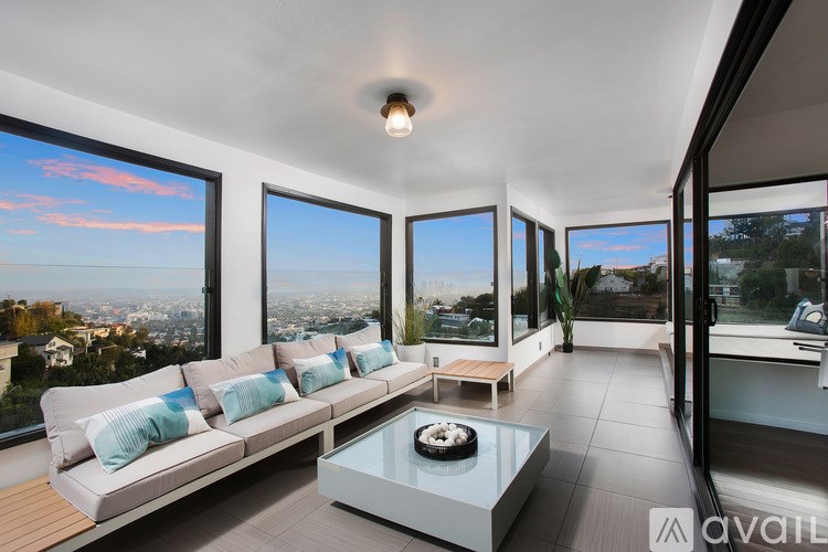 A modern living room with a view of the cityscape.