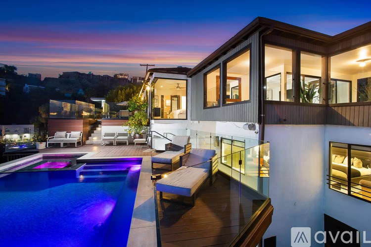 A modern house with a pool at dusk.