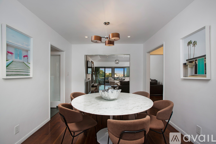 A modern dining room with a round table and chairs.