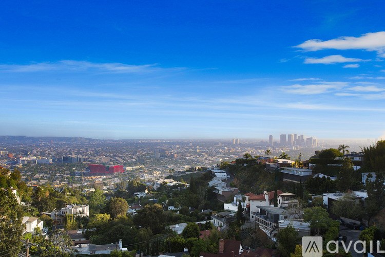 A cityscape with a clear blue sky and a distant skyline.