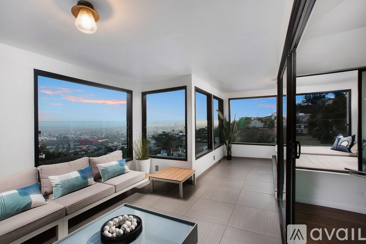 A modern living room with a view of the cityscape.