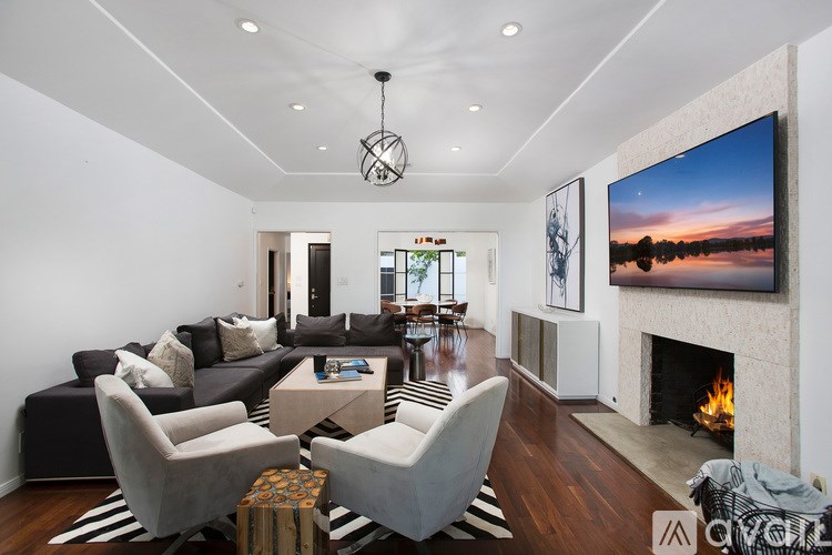 A modern living room with a fireplace and a large TV.