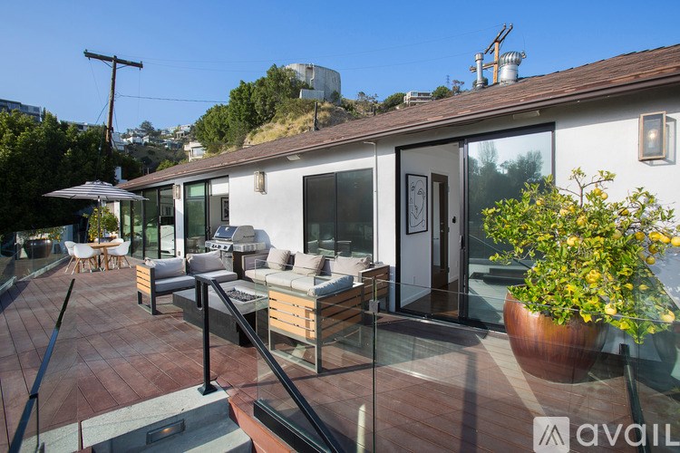 A patio with a table and chairs is on a roof.