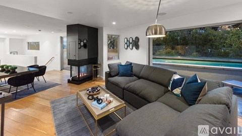 A modern living room with a grey sofa and a coffee table.