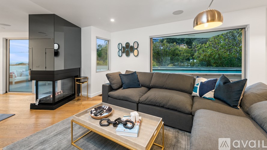 A modern living room with a grey sofa and a coffee table.