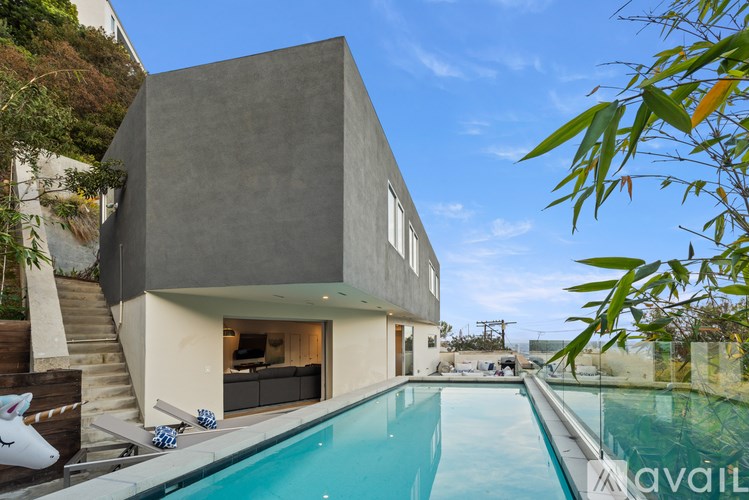 A modern house with a pool in the backyard.