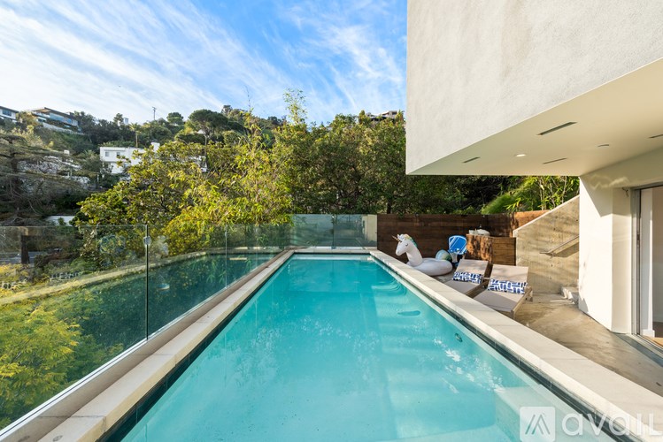 A long rectangular pool with a glass wall on one side.