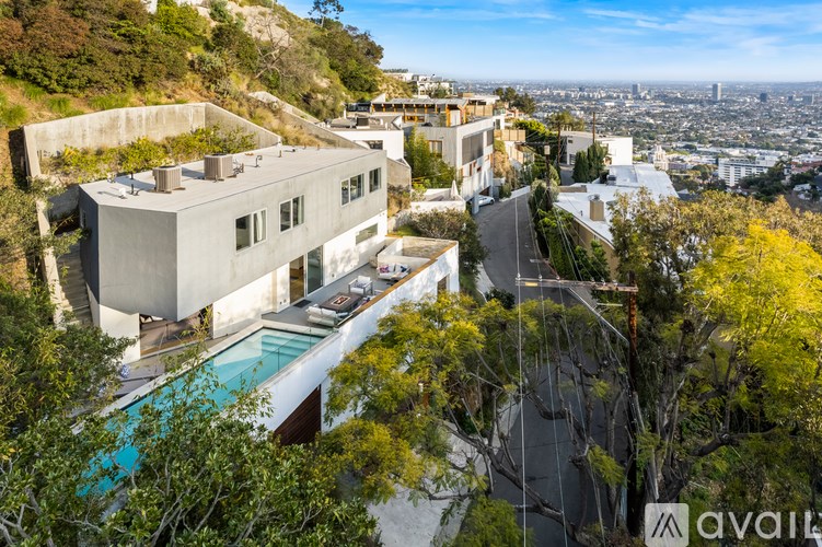 A modern house with a pool is for sale.