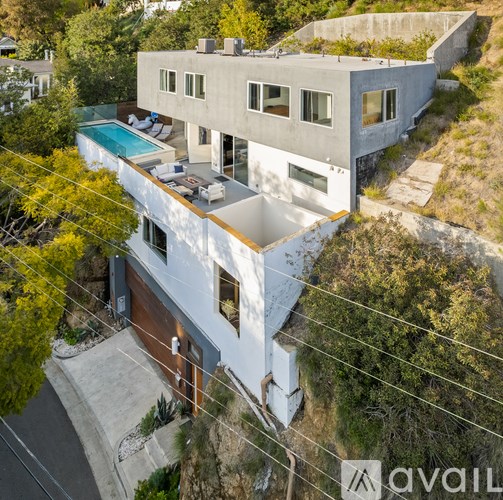 A modern house with a pool is for sale.