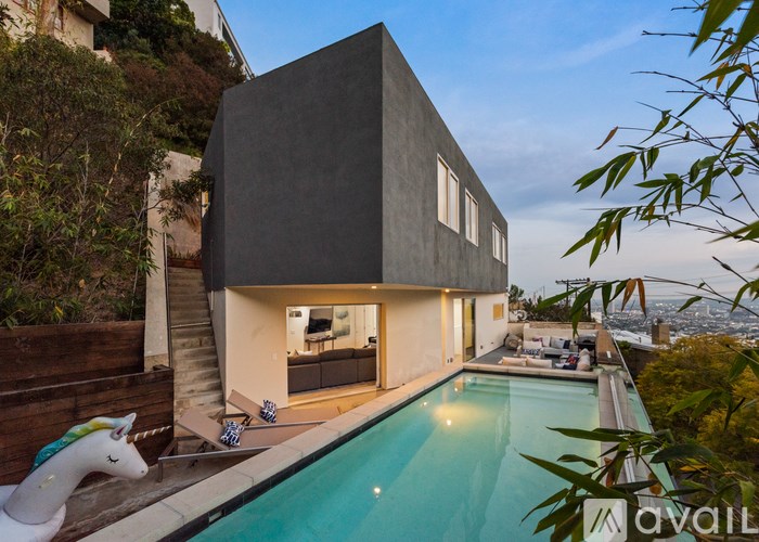A modern house with a pool in the backyard.