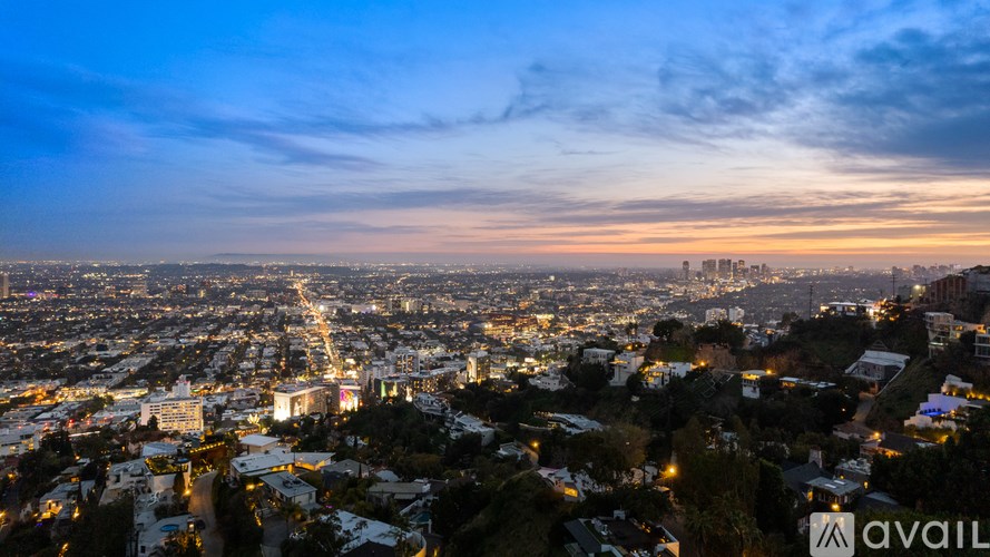 A cityscape at dusk with a clear view of the skyline and streets.