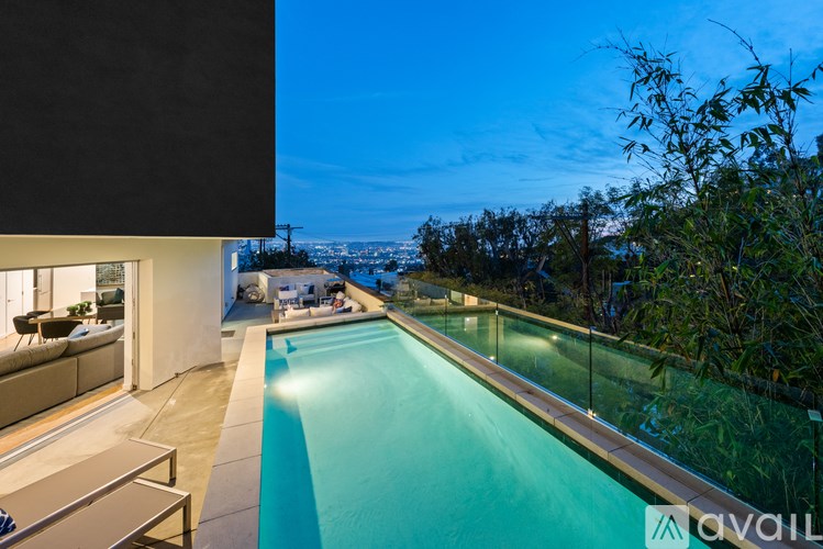 A modern house with a pool in the backyard.