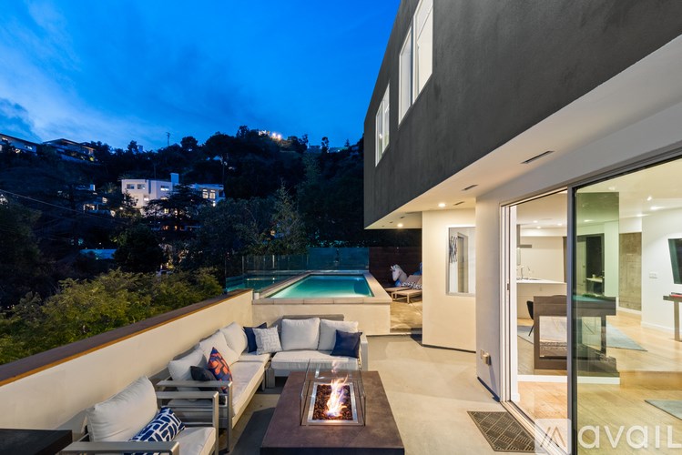 A modern house with a pool and a glass door.