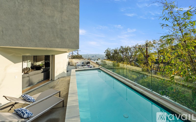 A modern house with a pool in the backyard.