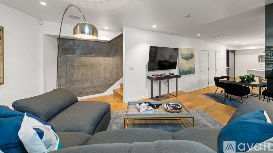 A living room with a grey sofa and a coffee table.