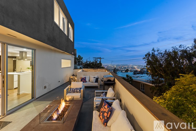 A modern house with a patio and a fire pit.