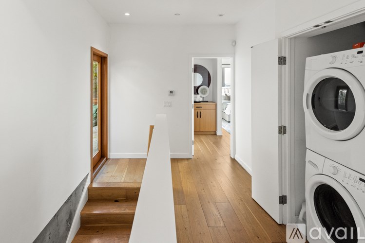 A modern laundry room with a washing machine and dryer.
