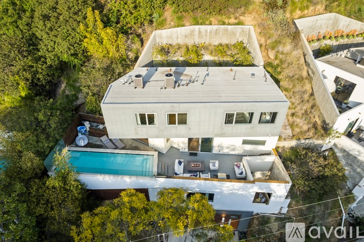 A modern house with a pool is for sale.