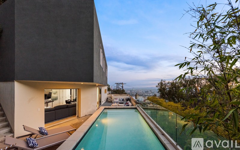 A modern house with a pool in the backyard.