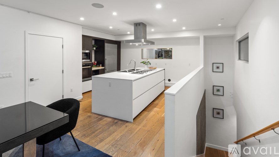 A modern kitchen with a dining table and chairs.