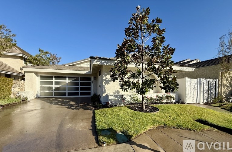 A house with a tree in front of it.