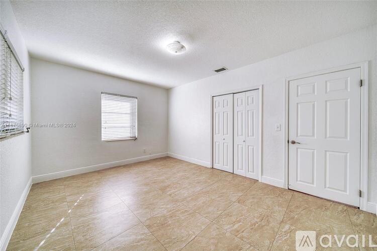 A room with white walls and a tiled floor.