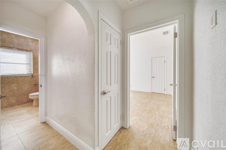 A bathroom with a toilet and a sink is shown.