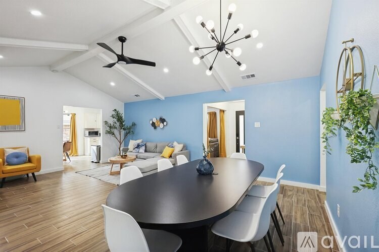 A modern dining room with a round table and chairs.