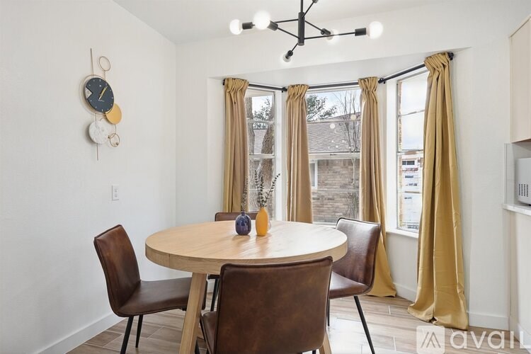 A dining room with a round table and chairs.