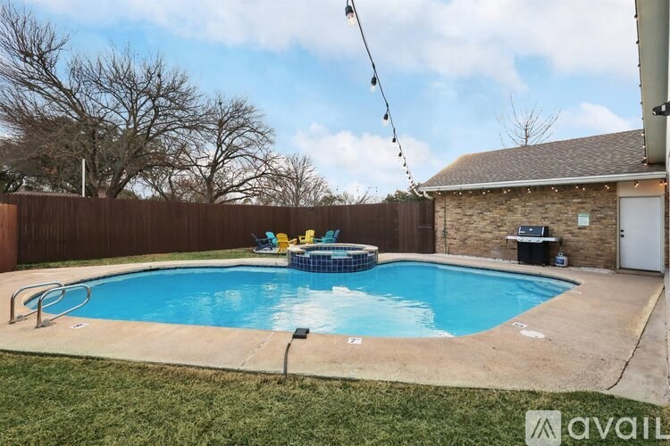 A backyard with a pool and a deck.