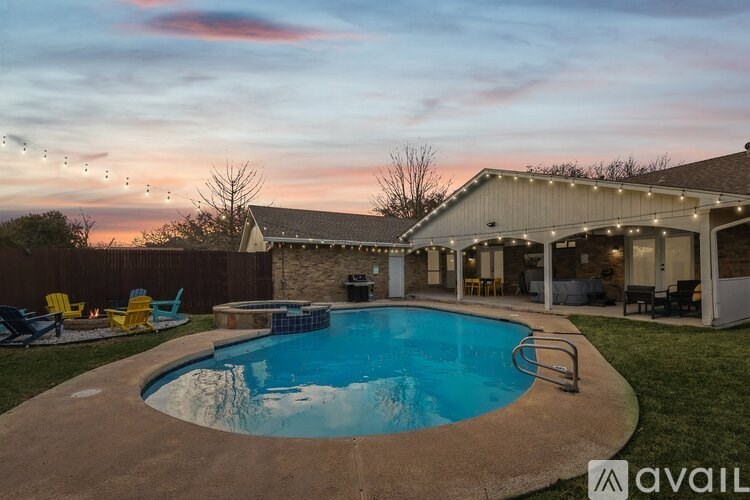 A backyard with a pool and a house with a sign that says "available".