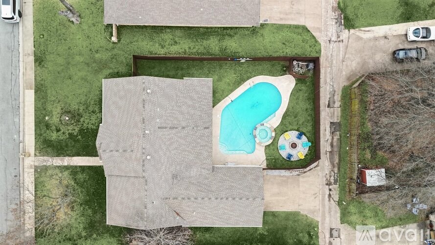 A backyard with a pool and a sandbox.