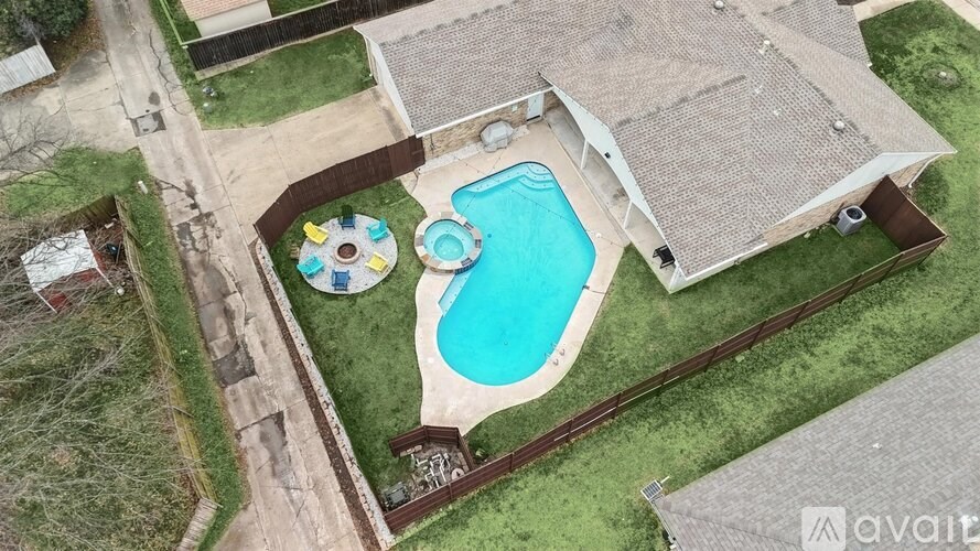 A backyard with a pool and a deck.